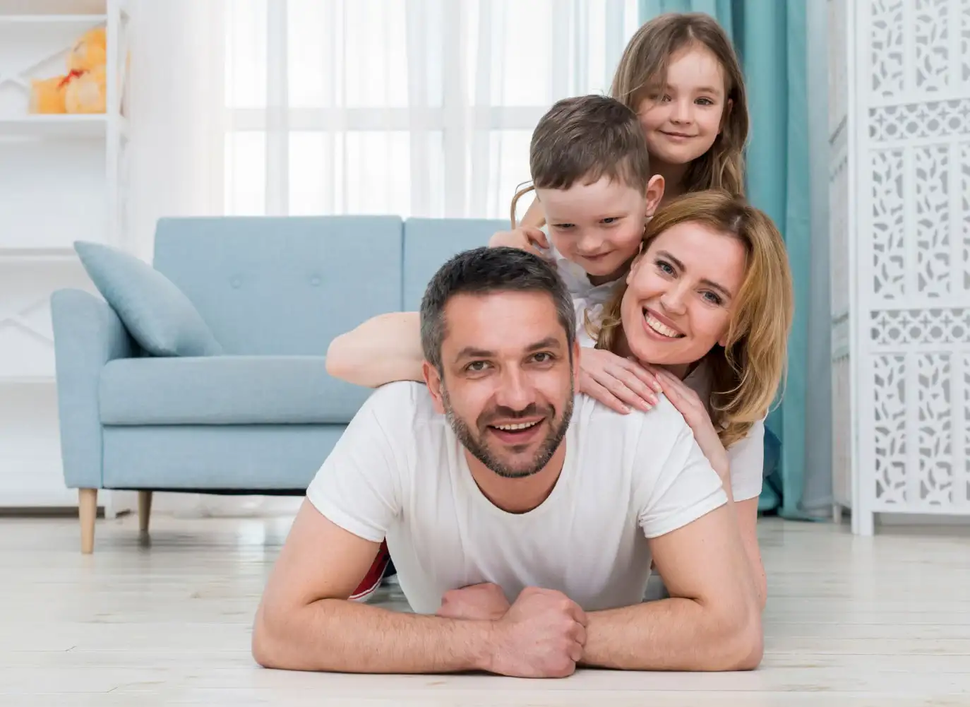 family of 4 piling on top of dad